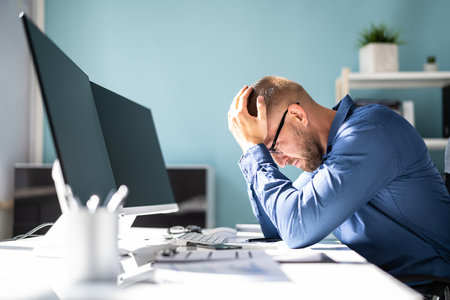 Stressed Sick Employee Man At Computer With Painの写真素材