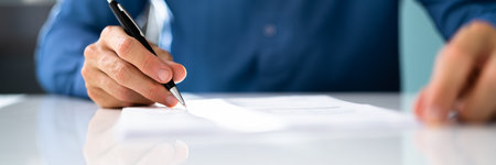 Agreement Signature With Pen. Hand Signing Paper Formの写真素材