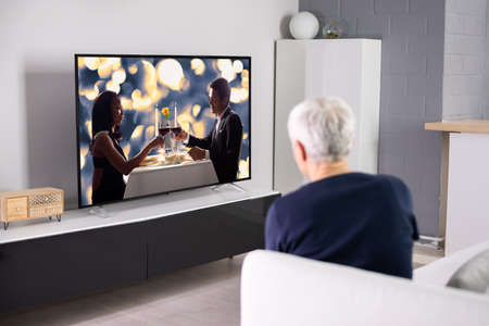 Watching TV Or Television In Living Room At Sofaの写真素材