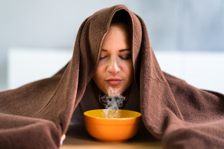 Woman Doing Inhalation Alternative Herbal Medicine Using Steam Bowlの写真素材