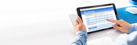 Woman Filling Online Survey Form On Tablet Computerの写真素材