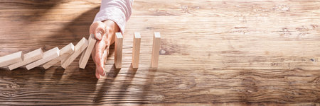 Domino Fall Prevention. Hand Stopping Blocks. Business Riskの写真素材