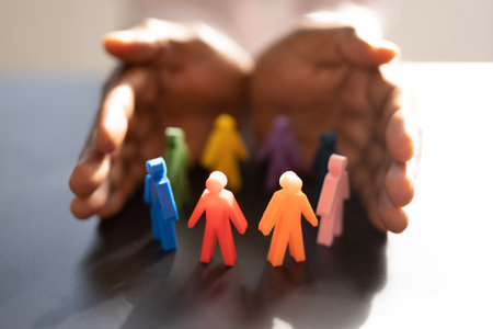 Inclusion And Diversity. Hand Protecting Inclusive Equal Pawnsの写真素材