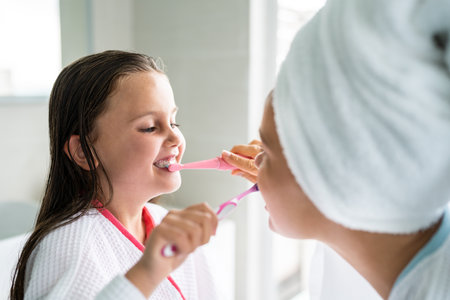 Daily Hygiene Teeth Brush Procedure In Bathroom With Child Daughterの写真素材