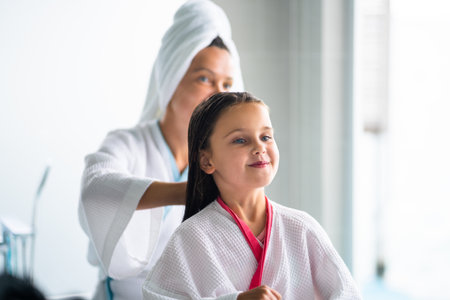 Mom Brushing Daughter Hair. Family Spa. Mother And Child Girl