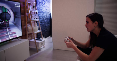 Rear View Of An Girl Playing Video Games At Home