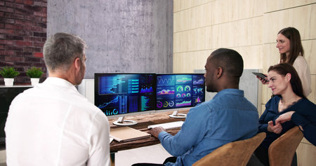 Financial Analysis Dashboard Meeting. Pointing At Report On Screen