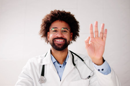 Doctor Waving In Online Video Call Meetingの写真素材