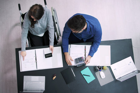 Accountant In Wheelchair In Office. Business Budget Meeting