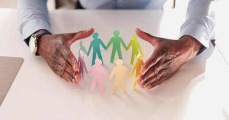 Inclusion And Diversity. Hand Protecting Inclusive Equal Pawnsの写真素材