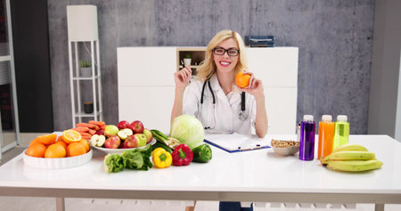 Portrait Of Female Dietician With Vegetables On Deskの写真素材