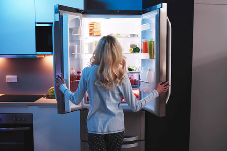 Hungry Woman At Night With Open Fridgeの写真素材