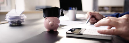 Student Loan Budget Calculator And Piggybank. Save Moneyの写真素材