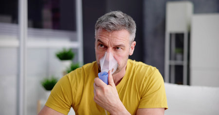 Asthma Patient Breathing Using Oxygen Mask And COPD Nebulizerの写真素材