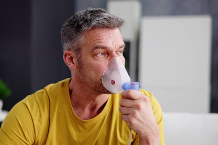 Asthma Patient Breathing Using Oxygen Mask And COPD Nebulizerの写真素材