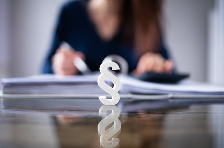 Close-up Of A Red Paragraph Symbol In Front Of Person Working At Workplace
