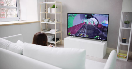 Child Playing TV Video Game Online In Living Room