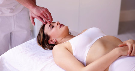 Portrait Of A Young Woman Getting Head Massage In Spaの写真素材