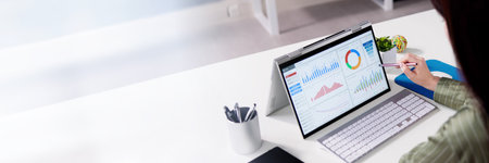Analyzing Data Graph And Dashboard On Laptop