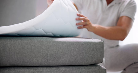 Mattress Topper Being Laid On Top Of The Bed