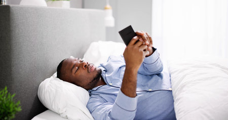 African Man Holding Smartphone Or Mobile Phoneの写真素材
