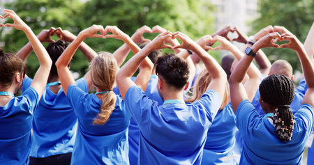 Diverse Young Charity Group Making Hearts Using Handsの写真素材