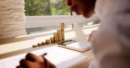 Accountant Calculating Tax Using Calculator On Desk. Save Money Conceptの写真素材