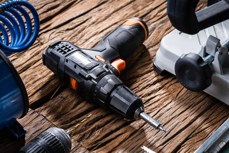 Various Power Tools Laying On Wooden Deskの写真素材