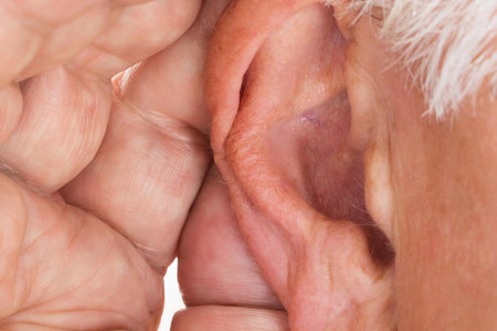 Close-up Of A Senior Man Trying To Hear Hand Over Earの写真素材
