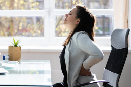 Bad Posture Sitting In Office With Backache In Chair