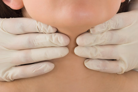 A Doctor Performing Physical Exam Palpation Of The Thyroid Gland