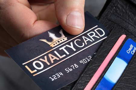 Close-up Of A Person's Hand Removing Black Loyalty Card From Walletの写真素材