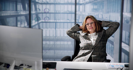 Relaxed Woman Taking a Breath on an Office Chairの写真素材