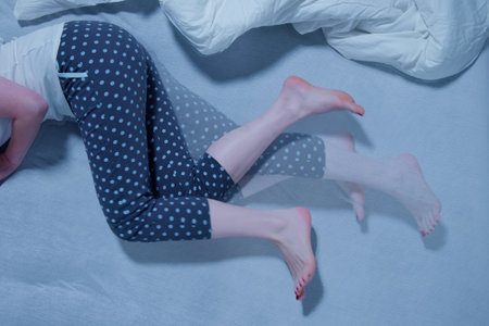 Restless Leg Syndrome: Woman Struggling to Sleepの写真素材