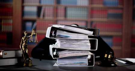 Young Stressed Male Lawyer Working With Stacked Foldersの写真素材