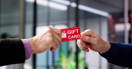 Hand Giving Gift Voucher Card. Holding Prepaid Coupon