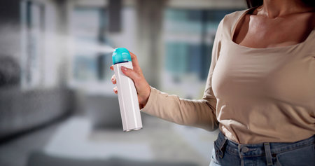 Woman Using Air Spray In Living Room