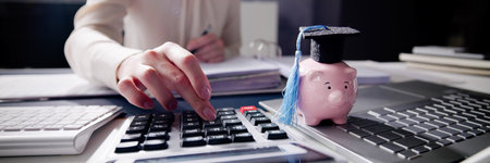 University student calculating accounting loan with credit cap calculator.の写真素材