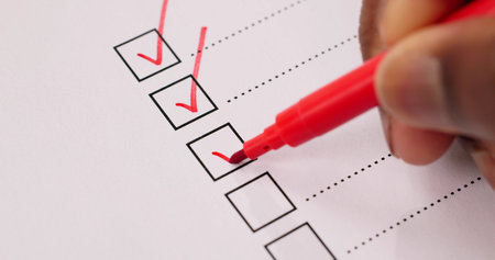 African American Hand Marking Check Mark In Checklist Surveyの写真素材