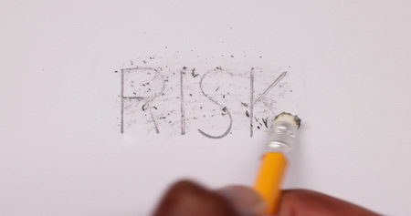 Pencil Eraser Erasing Risk Text On White Paper