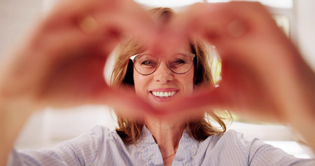 Woman Making Heart Sign. Senior Hands Romantic Love