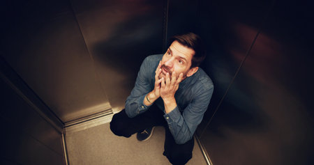 Man Suffering From Claustrophobia Trapped Inside Elevator