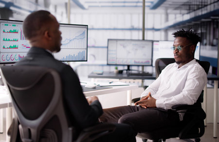 Two Businesspeople Talking With Each Other At Office