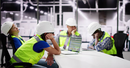 Diverse Engineers Bored At Meeting Training Presentation At Factory