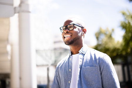 Young, Successful Corporate Manager Embracing Urban Life, Walking Down Busy City Streets Holding Briefcase, Exuding Confidence and Professionalism.の写真素材