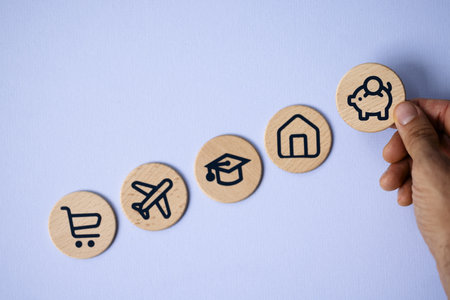 Financial Concept: A Caucasian Man Sitting at a Desk with a Piggy Bank, Cash, and Graduation Cap.の写真素材