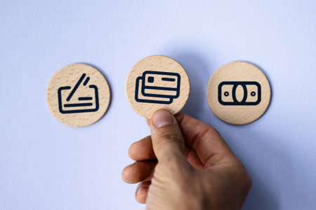 Digital Payment Concept: Man Using Smartphone for Cashless Transactions on Wooden Table with Electronic Finance Iconsの写真素材