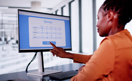 African Woman Filling Online Survey Form On Laptop Computer