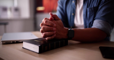 Christian Man Hand Praying With Bible Bookの写真素材