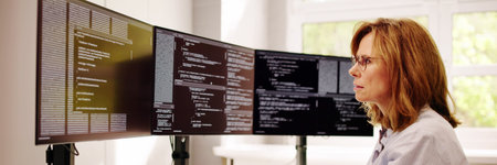 Software Programmer Or Coder Woman Using Office Computerの写真素材